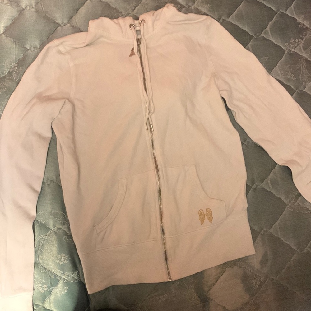 small, white and gold victoria’s secret supermodel essentials zip up jacket